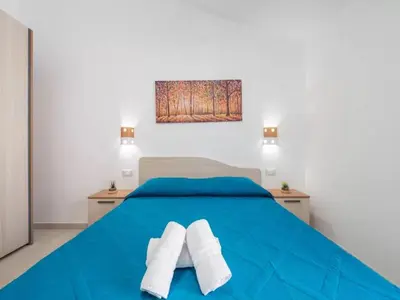 Letto o letti in una camera di San Teodoro Holiday Stay for 6