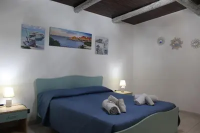 Letto o letti in una camera di Domo Marzellinu