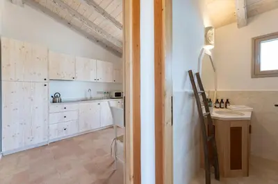 Cucina o angolo cottura di Menhir Boutique Apartments- Adult Only- by Obiettivo vacanza Budoni