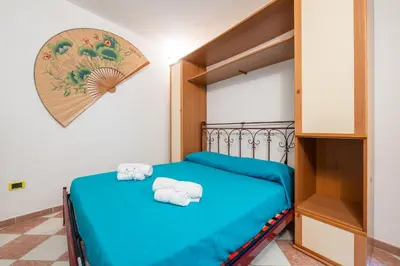Letto o letti in una camera di AffittaSardegna - Casa dei Pescatori