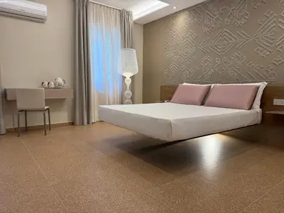 Letto o letti in una camera di MIRARI Design Rooms