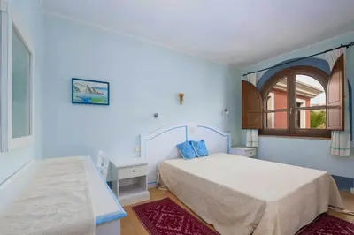 Letto o letti in una camera di Domu Joy - Appartamento - Prima Spiaggia