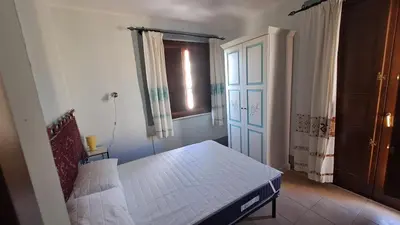 Letto o letti in una camera di Domu Joy - Appartamento - Prima Spiaggia