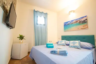 Letto o letti in una camera di B&B Sinis Domus