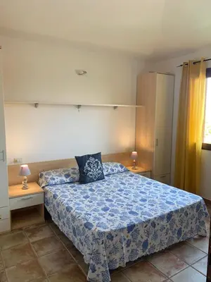 Letto o letti in una camera di Appartamento SAN TEODORO CENTRO