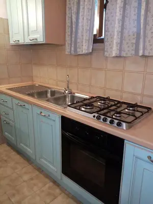 Cucina o angolo cottura di I Fenicotteri Baia Caddinas