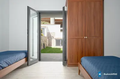 Letto o letti in una camera di Villa con piscina by budoniaffiti