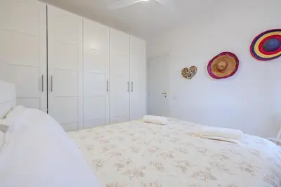 Letto o letti in una camera di Appartamento con 2 camere da letto Baia Turchese