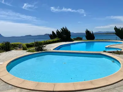 Piscina di Luxury apartment Ginestra sea view with common swimming pool just 50 mt from the beach o nelle vicinanze