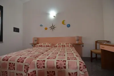 Letto o letti in una camera di APT 800 METRI Spiaggia Agrustos 2 PAX