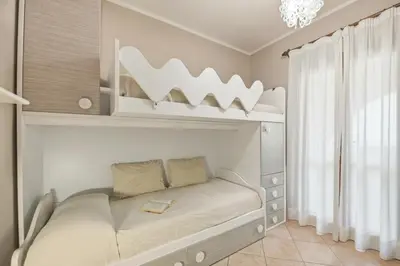 Letto o letti in una camera di Molara apartment by Residence Moresca, frontemare