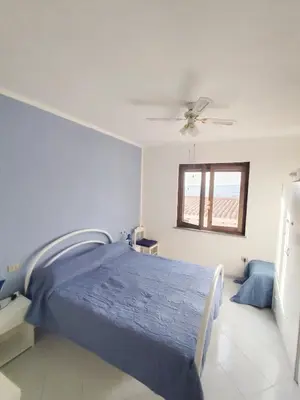 Letto o letti in una camera di Anna, trilocale a Budoni con splendida vista mare