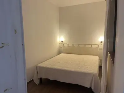 Letto o letti in una camera di Residence Porto Coda Cavallo