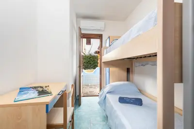 Letto o letti in una camera di Residenze Corallo - Cala Liberotto