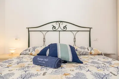 Letto o letti in una camera di Residenze Corallo - Cala Liberotto