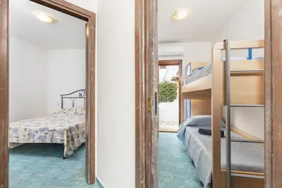 Letto o letti in una camera di Residenze Corallo - Cala Liberotto