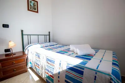 Letto o letti in una camera di Appartamenti Quercia e Olivo