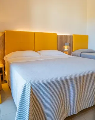 Letto o letti in una camera di Hotel San Teodoro