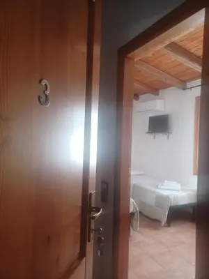 Letto o letti in una camera di B&B Helios Il Tuo Relax In Sardegna