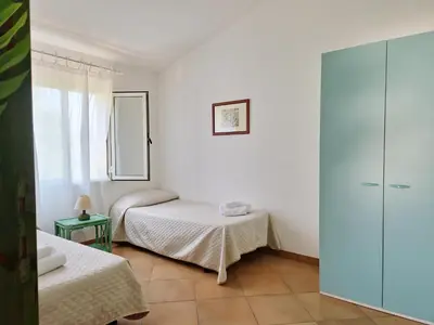 Letto o letti in una camera di Villa Scogliera - Appartamenti con veranda a circa 700 mt dalla spiaggia di Fuile e Mare