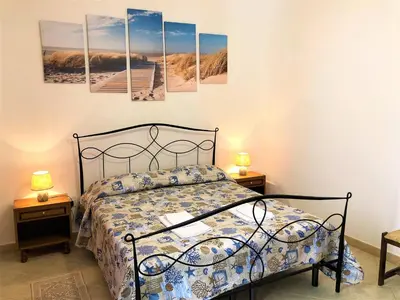 Letto o letti in una camera di Cala Gonone - Casa della Pineta