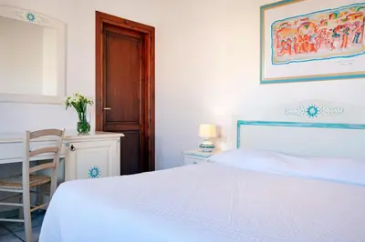 Letto o letti in una camera di Li Suari Club Village