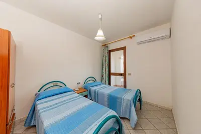 Letto o letti in una camera di Appartamento Residenziale Trilocale 4 posti letto via Sardegna San Teodoro