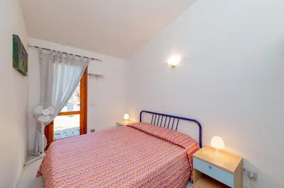 Letto o letti in una camera di Appartamento Trilocale Le Canne 6 posti letto con giardino