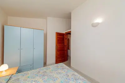 Letto o letti in una camera di Appartamento Trilocale Le Canne 6 posti letto con giardino