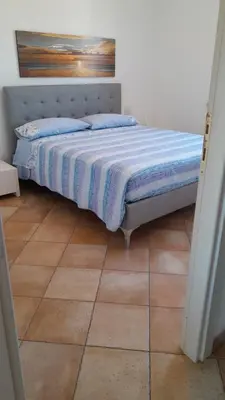 Letto o letti in una camera di Appartamento in residence fronte mare