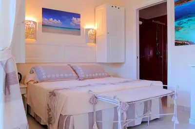 Letto o letti in una camera di Hotel Budoni Beach