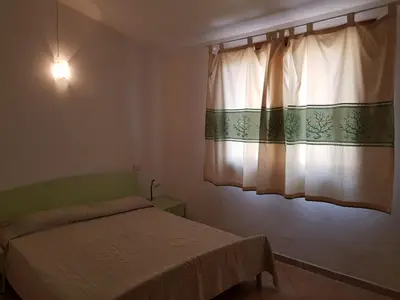 Letto o letti in una camera di Lulamax Sardegna