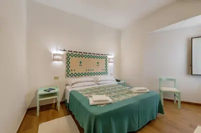 Letto o letti in una camera di Hotel Le Mimose