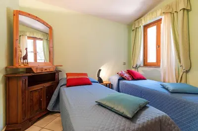 Letto o letti in una camera di Calagonone villetta con giardino e barbecue