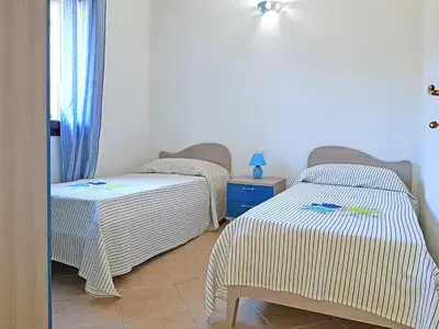 Letto o letti in una camera di villette acquamarina Budoni