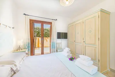 Letto o letti in una camera di Villa con vista Porto San Paolo
