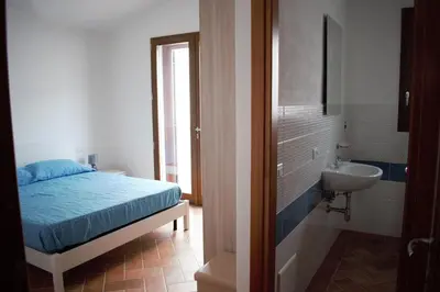 Letto o letti in una camera di VILLA FRANCESCA con vista mare La caletta SARDEGNA