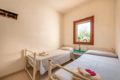 Letto o letti in una camera di Apartment in San Teodoro 23071