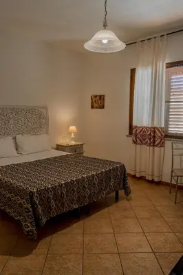 Letto o letti in una camera di B&B Il Corbezzolo