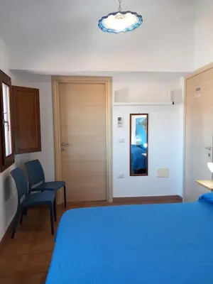 Letto o letti in una camera di AFFITTACAMERE DORGALI B&B da ZIETTO