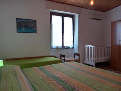 Letto o letti in una camera di AFFITTACAMERE DORGALI B&B da ZIETTO