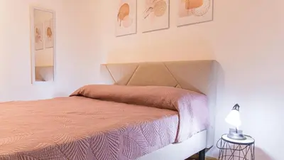Letto o letti in una camera di Casa Goletta soggiorno per 4 a 2 minuti dalla spiaggia IUNQ0334