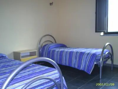 Letto o letti in una camera di casa con terrazza fronte mare