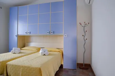 Letto o letti in una camera di Le Residenze di Baia Sant'Anna