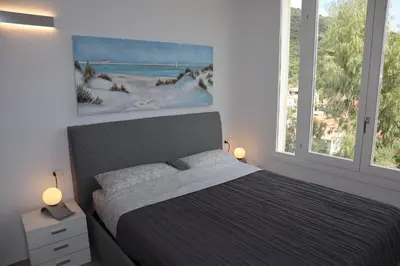 Letto o letti in una camera di neues Haus mit beheiztem Pool