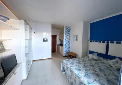 Letto o letti in una camera di San Teodoro Punta Est Delizioso Monolocale Vista Mare