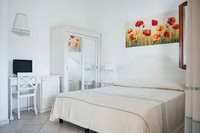 Letto o letti in una camera di SECRET VILLAGE Budoni