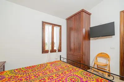 Letto o letti in una camera di Appartamento Trilocale Le Canne 4 posti letto con giardino e posto auto privato