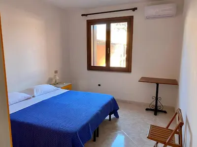 Letto o letti in una camera di Holiday House Olbia Downtown (giardino e ingresso indipendente)