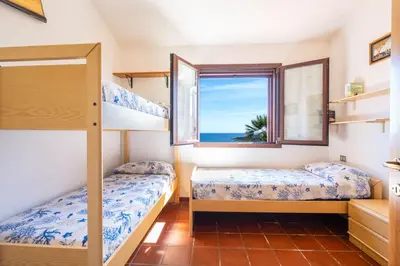 Letto o letti in una camera di Villino Tavolara a San Teodoro